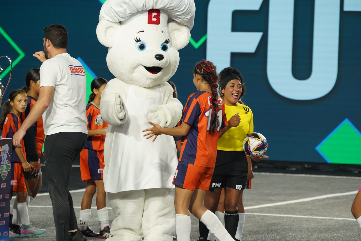Children playing at Futbolito Bimbo with the Bimbo bear mascot